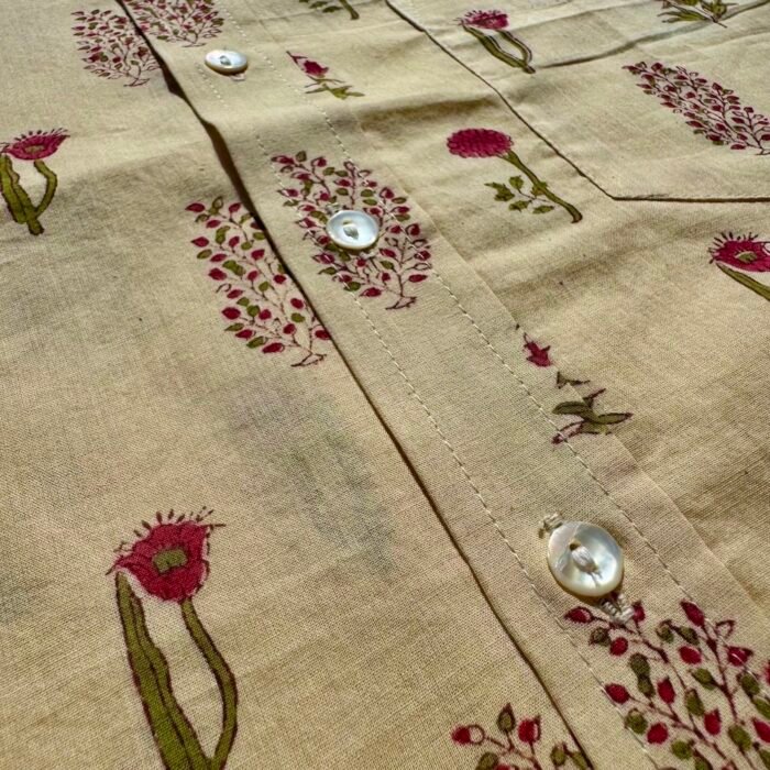 white shirt with red flowers grass adhukala